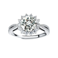 Close-up of sterling silver halo ring with brilliant round moissanite center stone surrounded by smaller accent stones