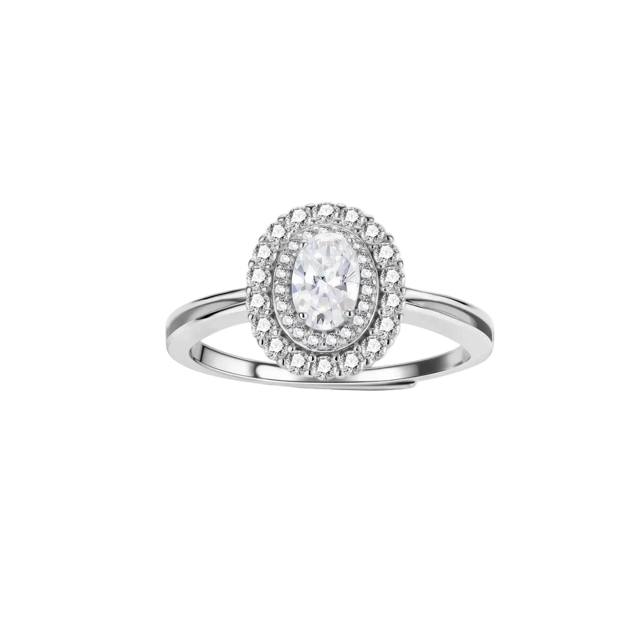 Sterling silver ring with oval moissanite center stone surrounded by double halo of sparkling stones on neutral background.