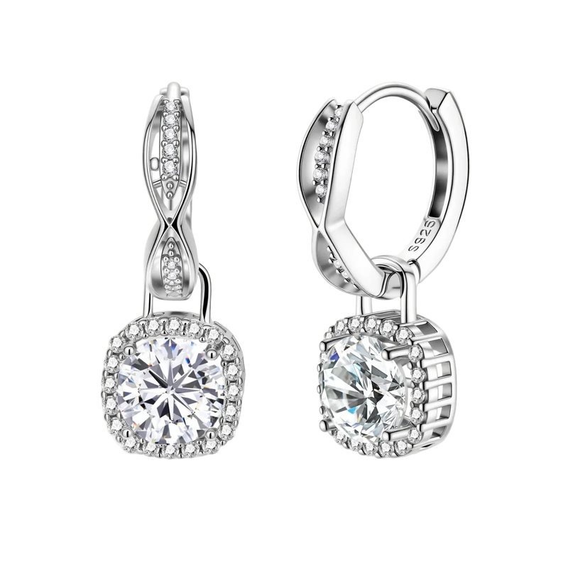 Sterling silver twisted hoop earrings with round moissanite stones in halo settings against neutral background.