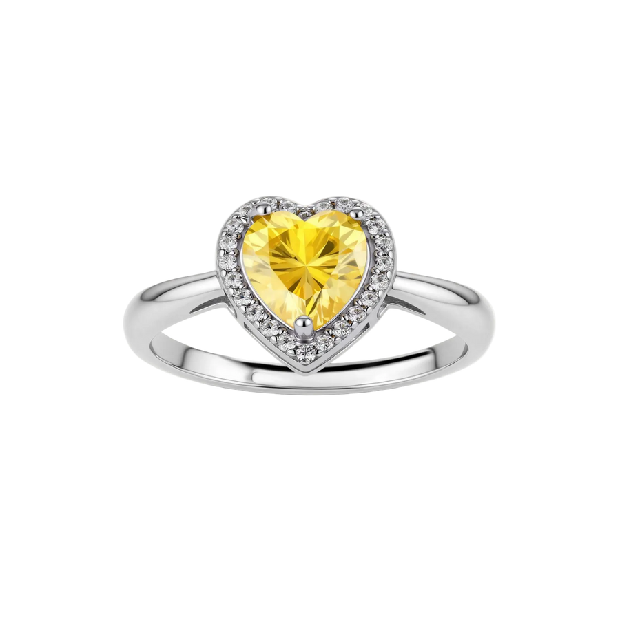 Heart-shaped yellow moissanite ring with diamond halo in sterling silver setting on neutral background