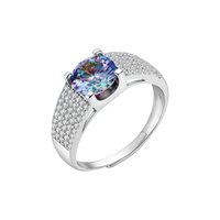 Sterling silver adjustable ring with brilliant round moissanite center stone and pavé diamond band showing rainbow fire