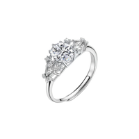 Sterling silver ring with oval moissanite center stone surrounded by smaller accent stones in ornate setting