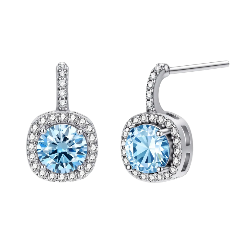 Sterling silver drop earrings featuring cushion-cut blue moissanite stones surrounded by sparkling halo settings