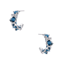 White gold plated hoop earrings with woven blue denim fabric through organic branch-like metal framework