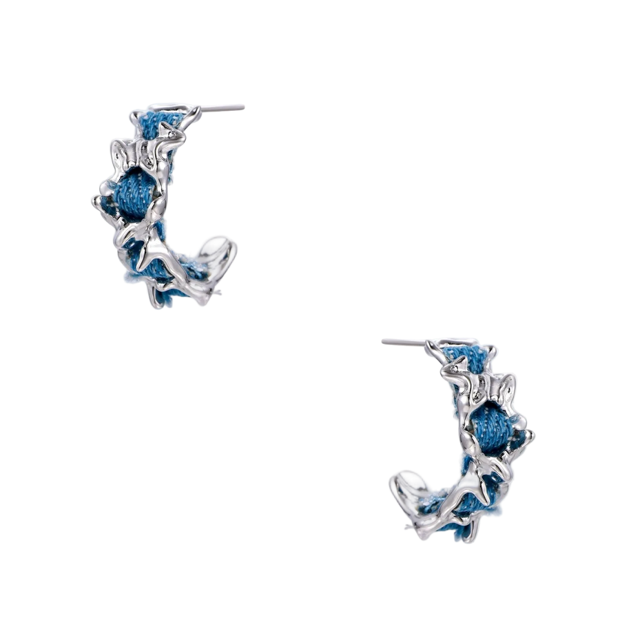 White gold plated hoop earrings with woven blue denim fabric through organic branch-like metal framework