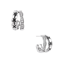 Triple-row white gold hoops with black X-pattern, twisted band, and pavé zirconia stones on white background.