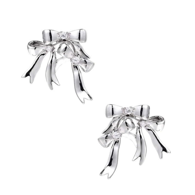 Sculptural bow earrings in polished white gold plate with sparkling zirconia stones and flowing ribbon details