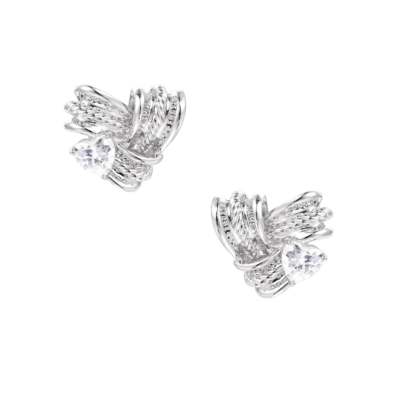 Pair of sculptural white gold-plated stud earrings with twisted ribbon design and sparkling zirconia stones on cream background