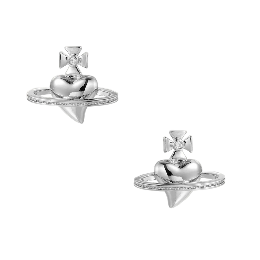 Polished white gold-plated Saturn planet stud earrings with orbital rings and crystal-centered cross on beige background