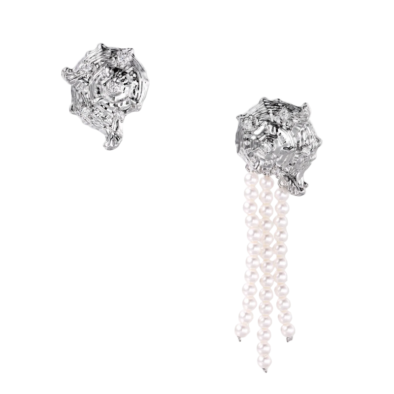 Silver-toned sculptural panther head earrings with zirconia details and white pearl drops on cream background