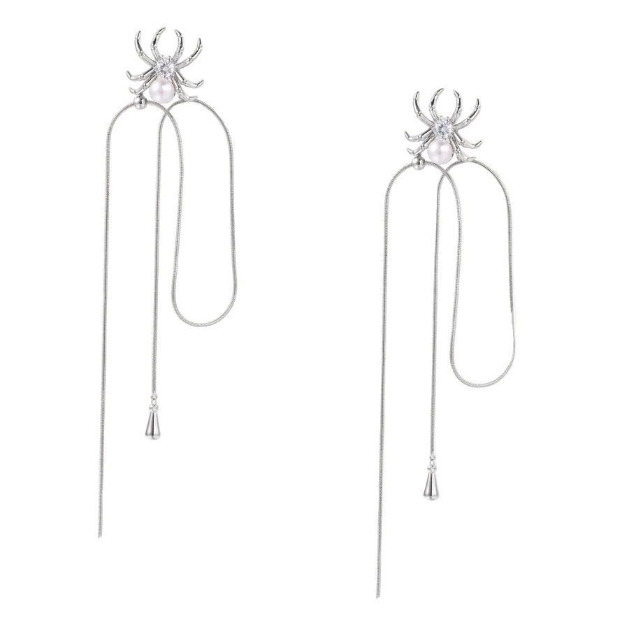 White gold plated spider earrings with pearl body and long threader chains on beige background