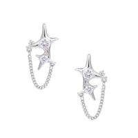 Silver star studs with crescent moon cutouts and zirconia stones connected by delicate chains on white background