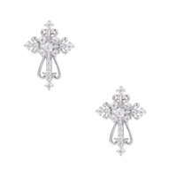 White gold-plated baroque cross studs with zirconia stones and ornate scrollwork on cream background.