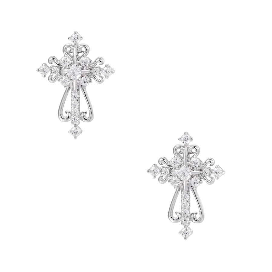 White gold-plated baroque cross studs with zirconia stones and ornate scrollwork on cream background.