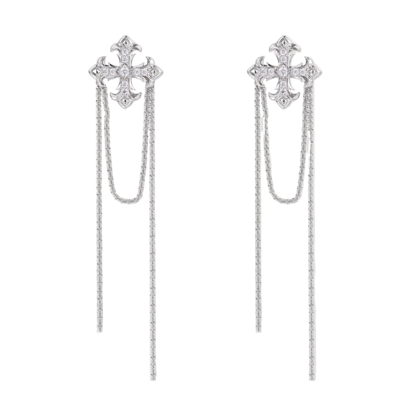 White gold plated baroque cross stud earrings with long cascading zirconia chains on cream background