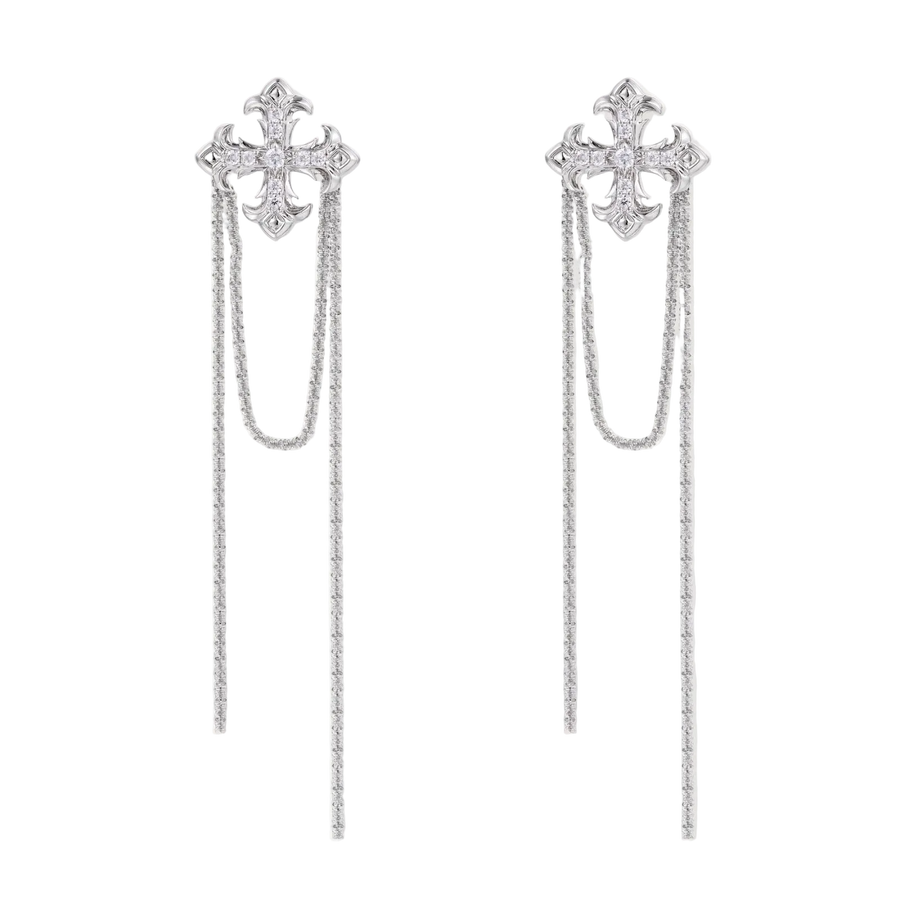 White gold plated baroque cross stud earrings with long cascading zirconia chains on cream background