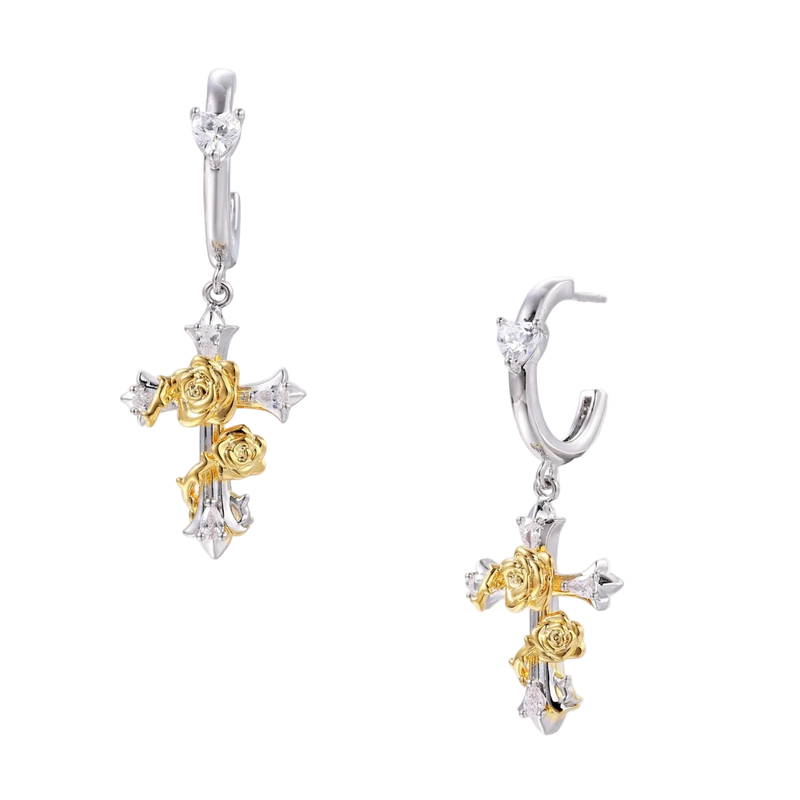 Two-tone huggie hoops with gold rose crosses and star zirconia accents on cream background