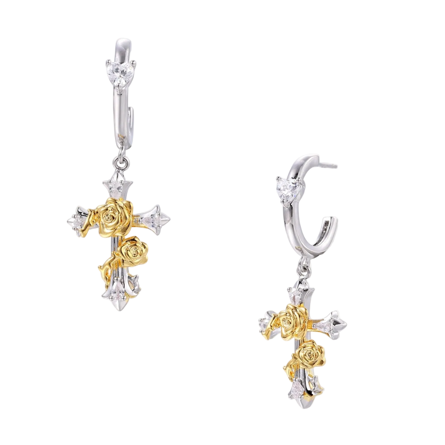 Two-tone huggie hoops with gold rose crosses and star zirconia accents on cream background