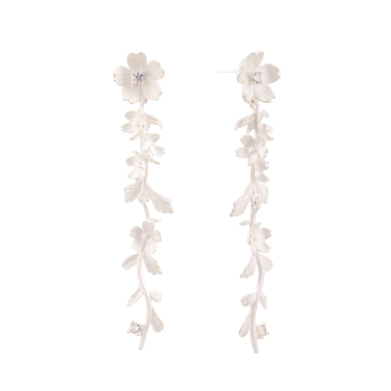 Long sterling silver drop earrings with delicate floral vine design and crystal accents on white background