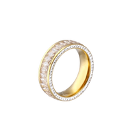 14K gold-plated ring with dual rows of clear baguette and round zirconia stones on cream background.
