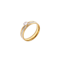 Gold-plated double-band ring with center rhinestone solitaire and channel-set stones on white background