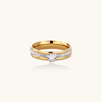 Gold-plated double-band ring with center rhinestone solitaire and channel-set stones on white background