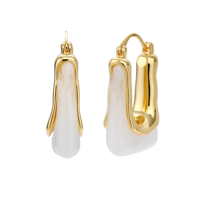 Sculptural gold-plated hoop earrings with flowing curved design and lever-back closure on cream background.