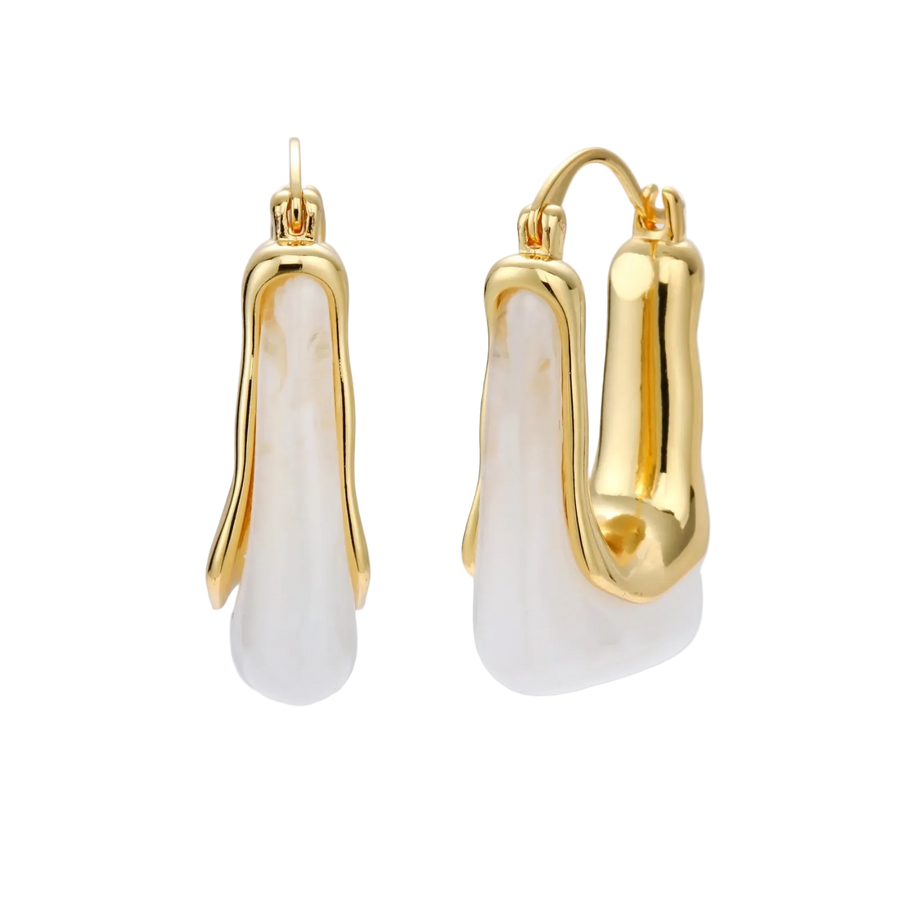 Sculptural gold-plated hoop earrings with flowing curved design and lever-back closure on cream background.