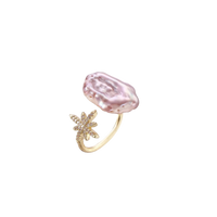 Adjustable gold ring with pink baroque freshwater pearl and crystal-studded star charm on white background