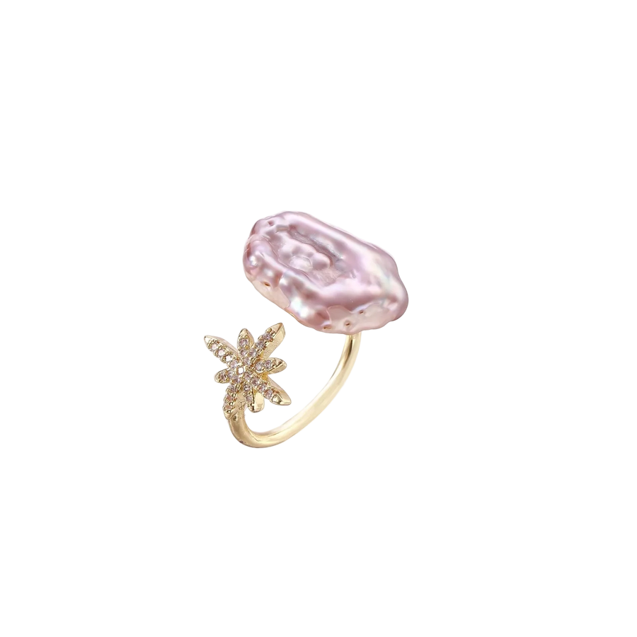 Adjustable gold ring with pink baroque freshwater pearl and crystal-studded star charm on white background