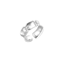 Adjustable silver-toned ring with sculptural stitch design across polished white gold-plated brass band