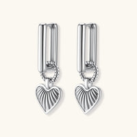 Platinum-plated 925 sterling silver rectangular hoop earrings with twisted ring connector and ribbed heart charm pendant.