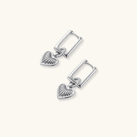 Platinum-plated 925 sterling silver rectangular hoop earrings with twisted ring connector and ribbed heart charm pendant.