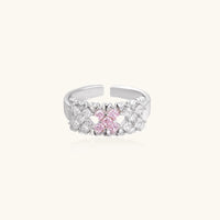 Close-up of an adjustable white gold plated ring featuring a cluster of square-cut clear and pink zirconia stones in geometric arrangement.