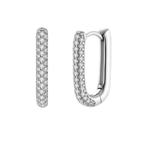 Close-up of platinum-plated sterling silver huggie hoops with pavé crystal setting on white background.