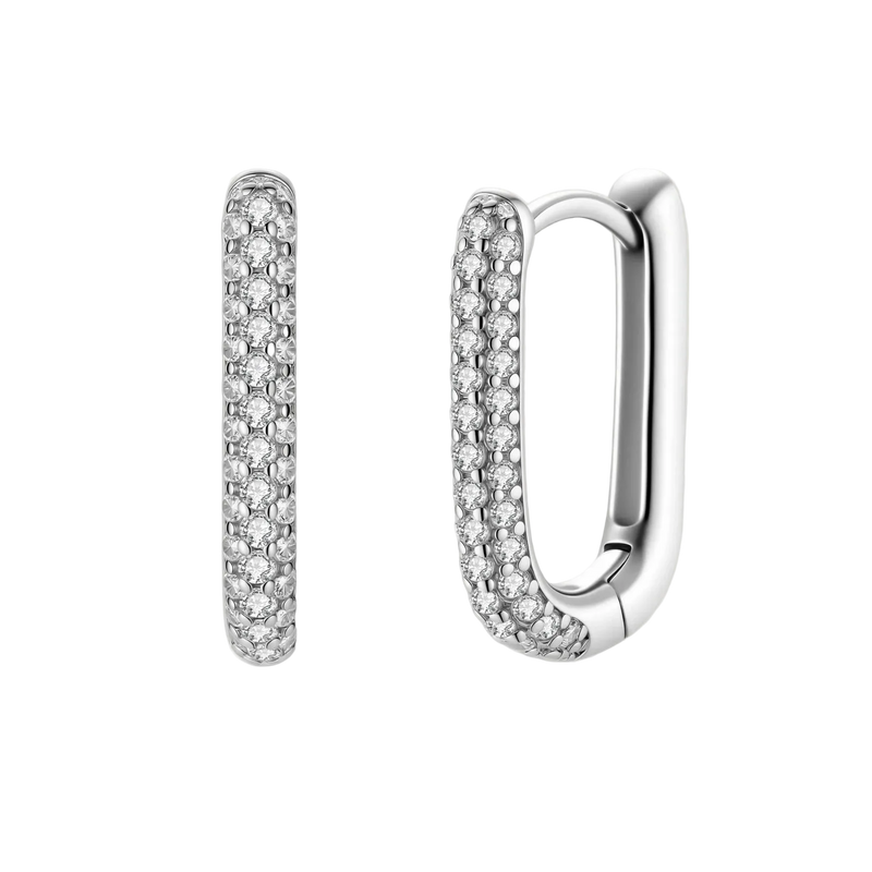 Close-up of platinum-plated sterling silver huggie hoops with pavé crystal setting on white background.
