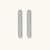 Close-up of platinum-plated sterling silver huggie hoops with pavé crystal setting on white background.
